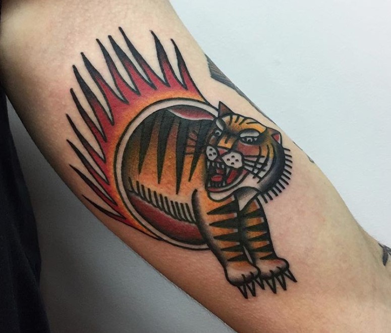 A colored traditional tattoo on the biceps