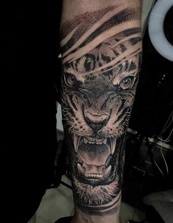 black and gray 3D angry face of a Tiger Tattoo on the forearm