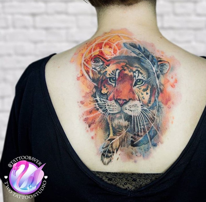 Realistic face of an orange Tiger Tattoo on the back