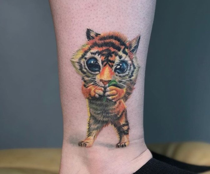 Cute tiger cub tattoo on the leg