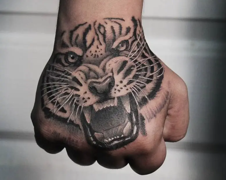 3D angry face of a Tiger Tattoo on the hand