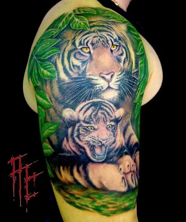 Two realistic Tigers in the forest tattoo on the shoulder