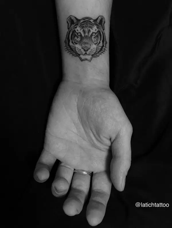 face of a black and gray Tiger Tattoo on the wrist