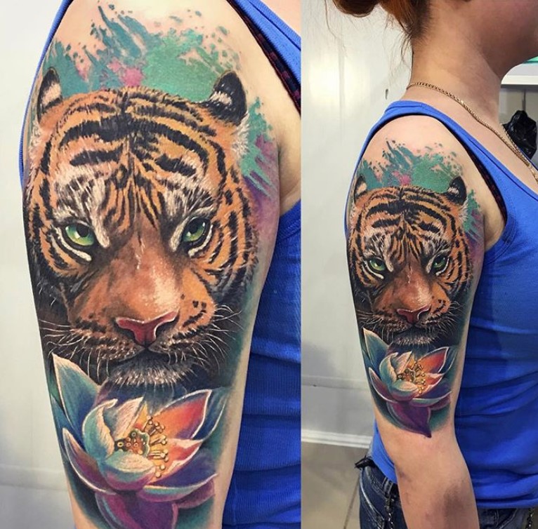 Realistic Orange Tiger Tattoo on the shoulder of a woman