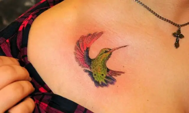 green, pink, and blue colored Hummingbird Watercolor Tattoo on the chest