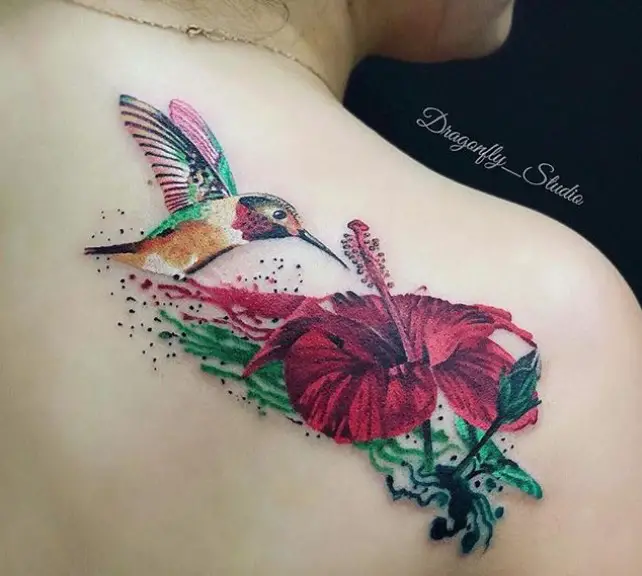 hummingbird feeding on a red hibiscus flower tattoo on the shoulder