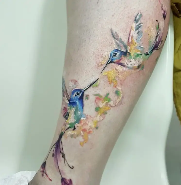two hummingbirds watercolor tattoo on the leg