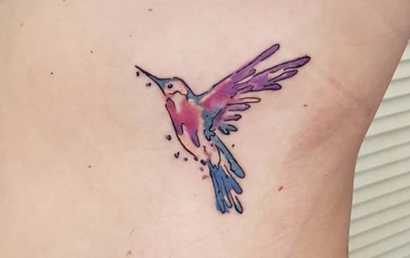 purple and blue watercolor hummingbird tattoo