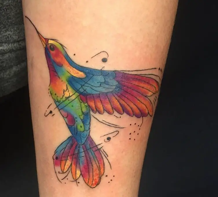 hummingbird in vibrant colors tattoo on the forearm