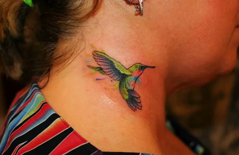 small colorful hummingbird tattoo on the neck