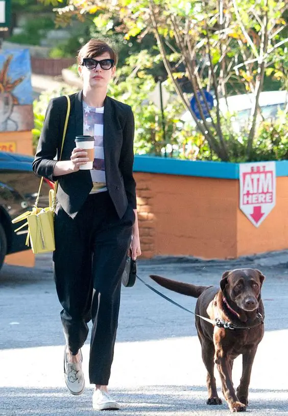 Anne Hathaway walking with her Labrador