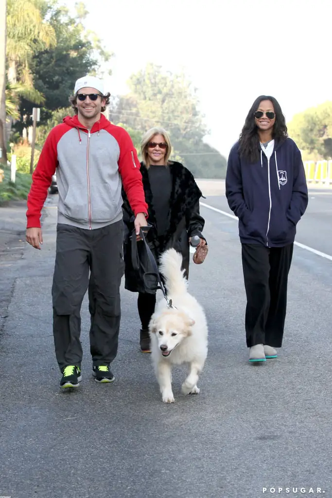 Bradley Cooper, Zoe Saldana, and Bradley’s mom walking in the street with their Samoyed Dog