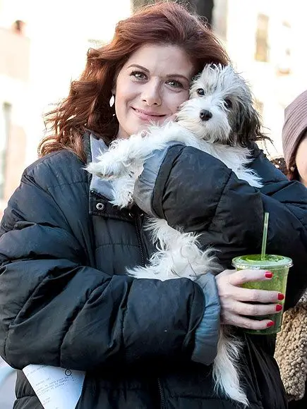 Debra Messing hugging her dog