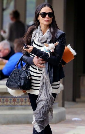 Demi Moore with her Chihuahua in her arms while walking in the street