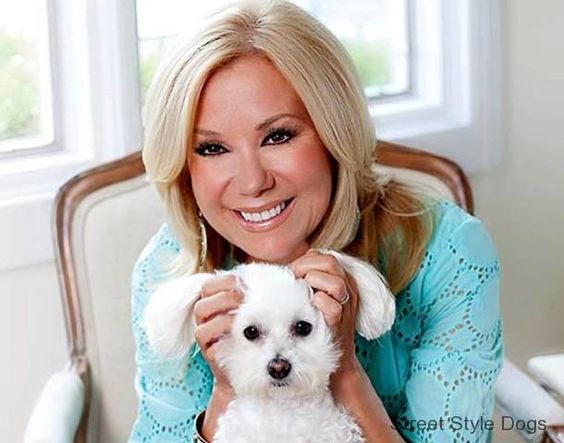 Kathie Lee sitting on the chair while touching the ears of her Bichon Frise