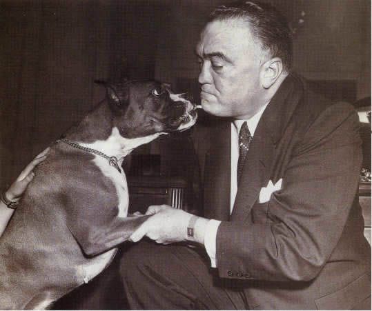 Edgar Hoover with his Boxer Dog licking his chin