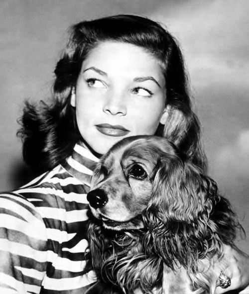 Lauren Bacall and her Cocker Spaniel looking sideways