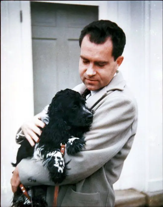 Richard Nixon carrying his Cocker Spaniel