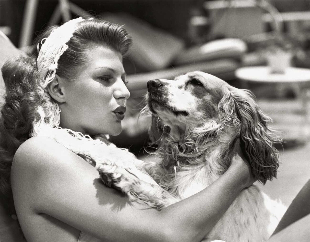 Rita Hayworth petting her Cocker Spaniel