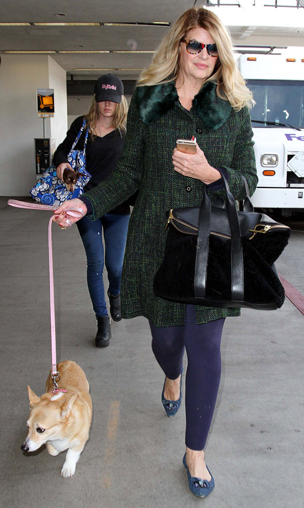 Kirstie Alley walking in the parking lot with her Corgi