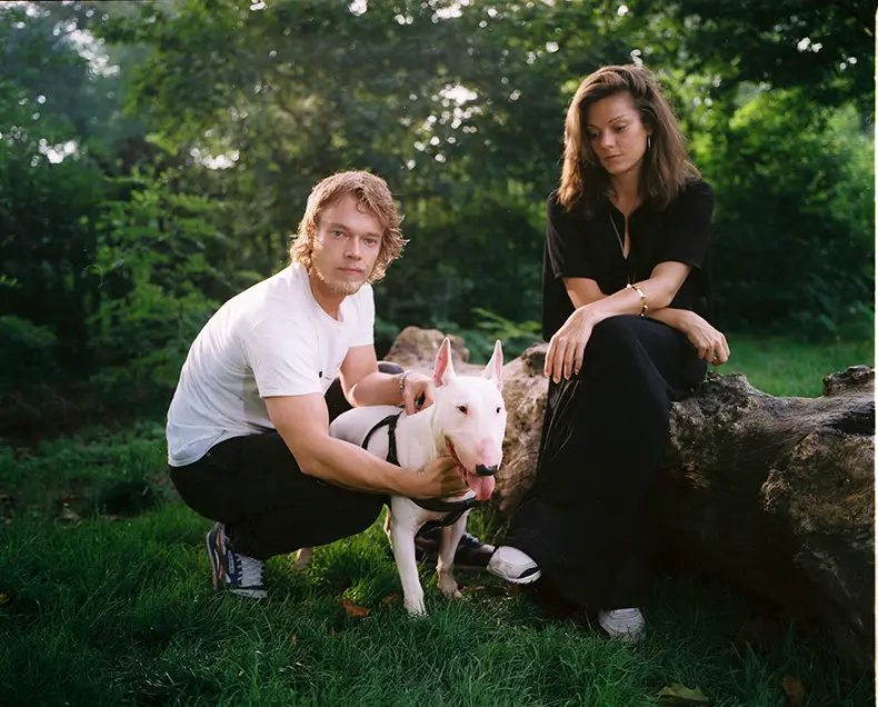 Alfie Allen with Maggie May and Sarah in the forest with their English Bull Terrier