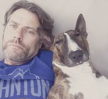 John Bishop beside his English Bull Terrier