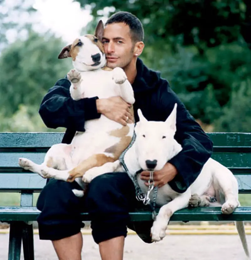 Marc Jacobs sitting on the bench with his two English Bull Terriers