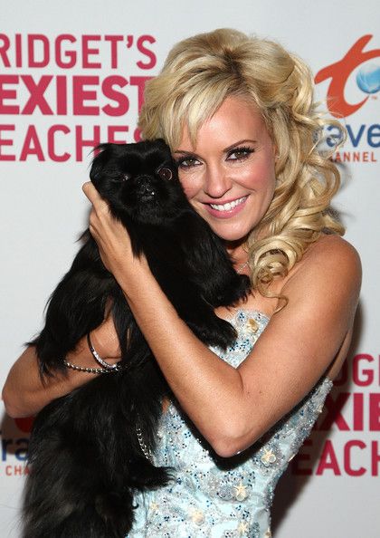 Bridget Marquardt hugging her plain black Pekingese 