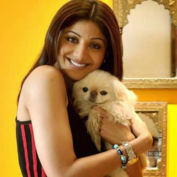 Shilpa Shetty hugging her Pekingese puppy