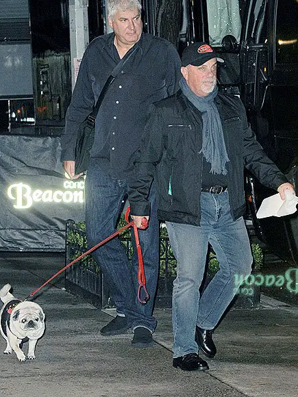 Billy Joel walking with his Pug on a leash