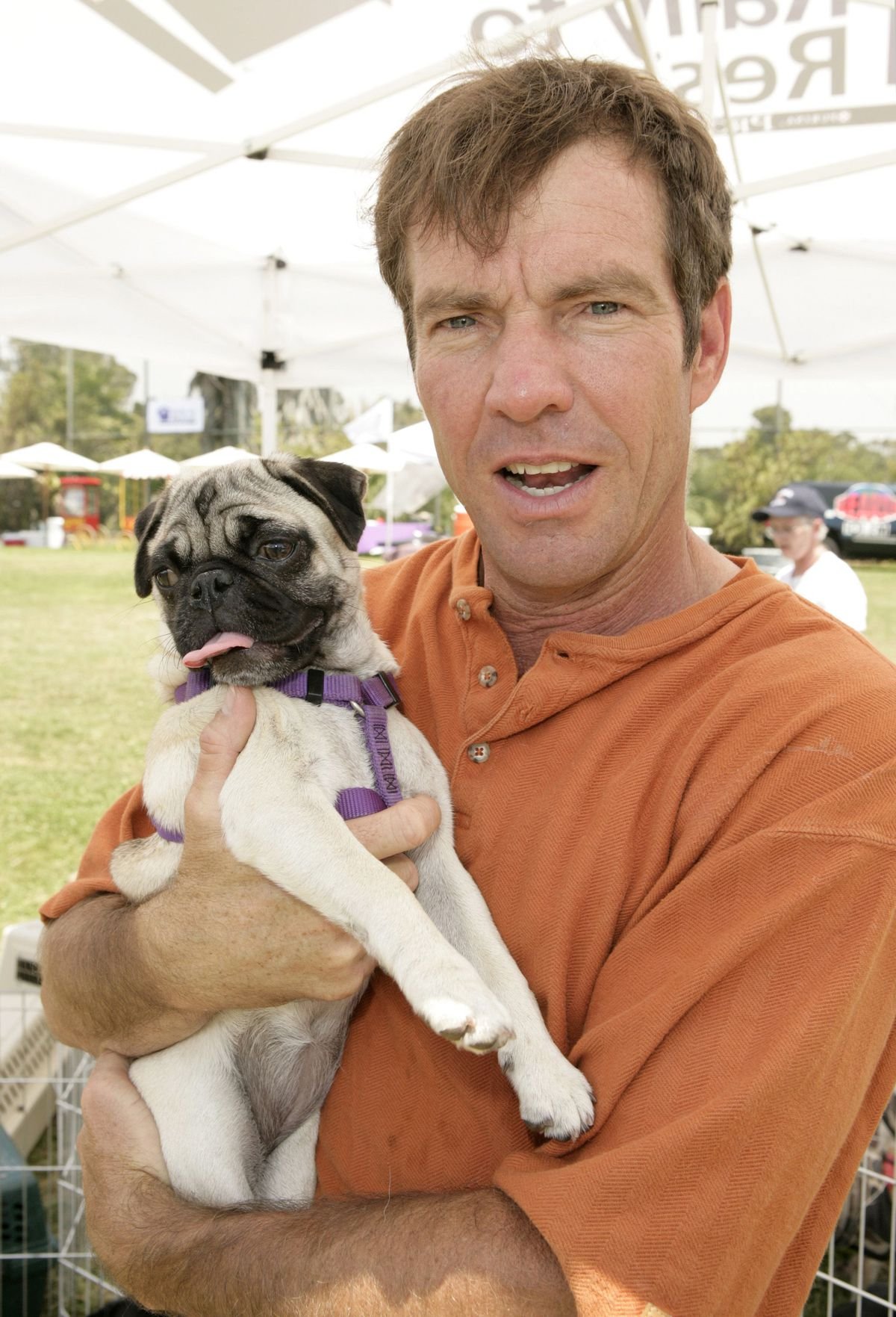Dennis Quaid holding his pug