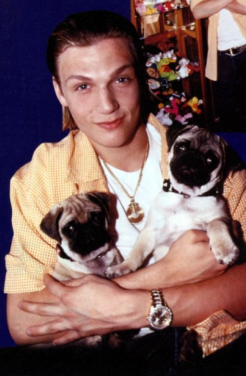 Nick Carter holding is two Pug puppies