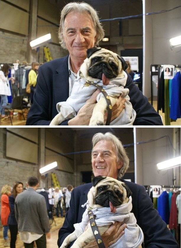 Paul Smith holding his pug wearing a sweater