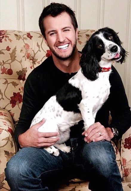 Luke Bryan sitting on the sofa with his Springer Spaniel in his lap