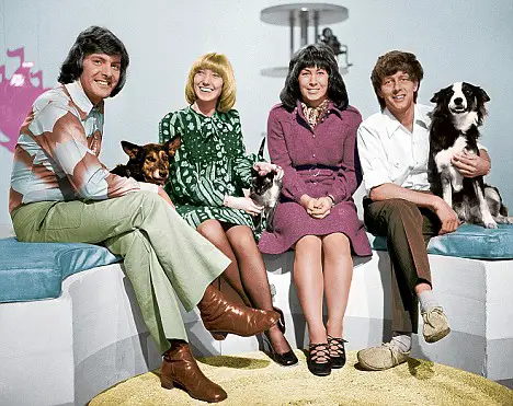 the Blue Peter show with a Border Collie sitting next to the man in whit shirt
