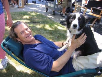 Jeff Bridges lying on the folding bed with his Border Collie sitting on his lap