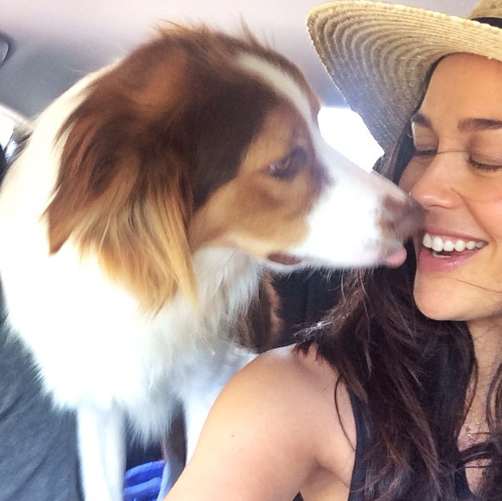 Megan-Gale taking a selfie while her Border Collie is licking her mouth