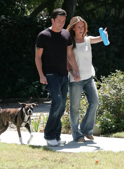 Jennifer Love Hewitt walking at the park with her boyfriend and their Boxer dog