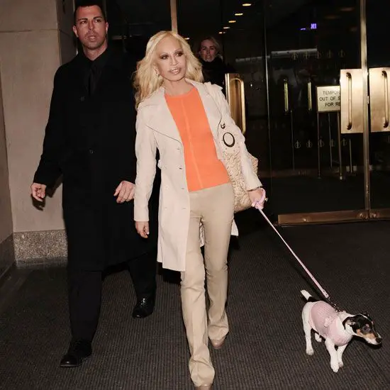 Donatella Versace walking with her Jack Russell on a leash