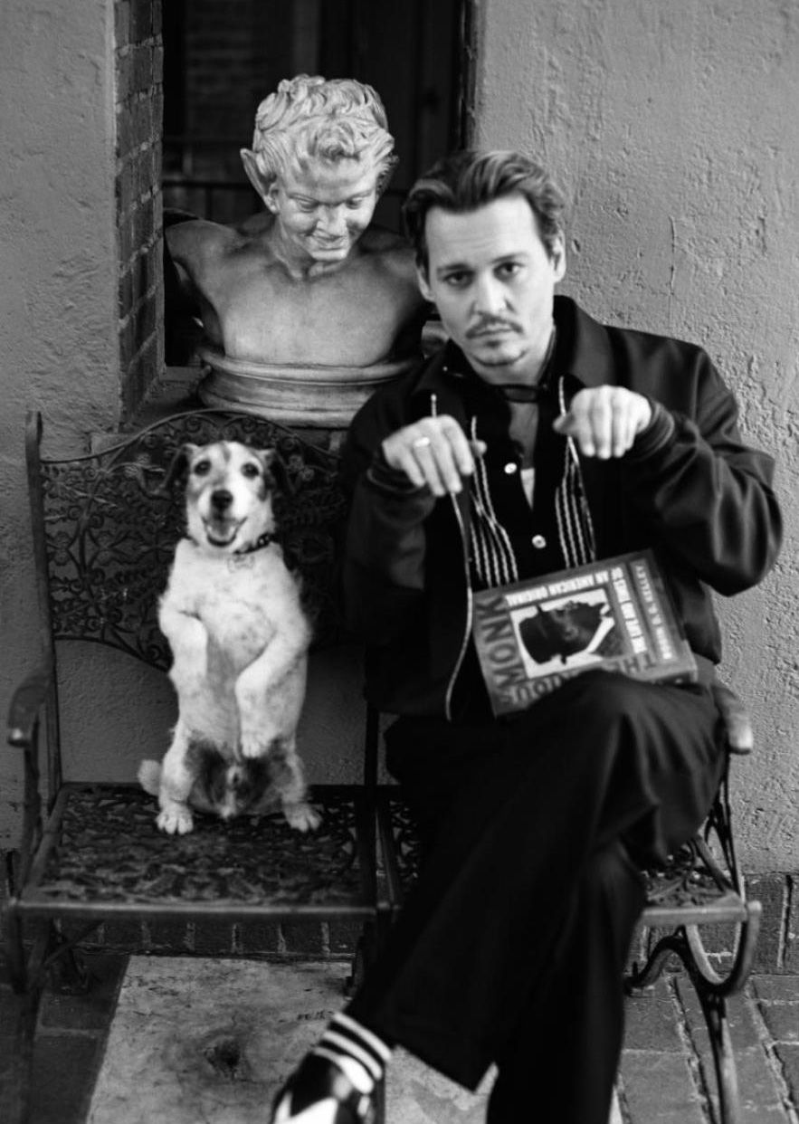 black and white photo of Johnny Depp with its sitting pretty Jack Russell