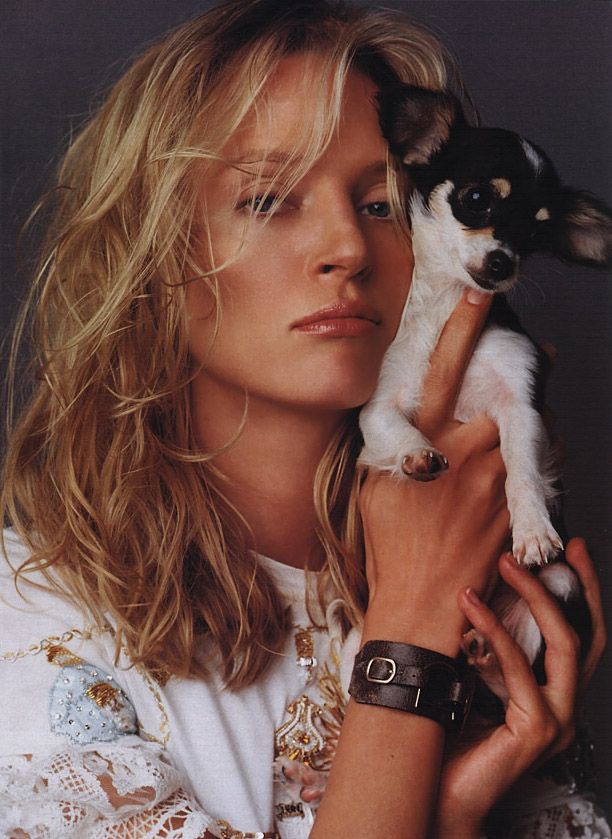 Uma Thurman holding up her Chihuahua beside her face