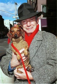 Ben Gazarra carrying his dachshund dog