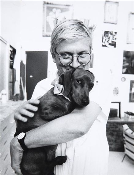 David Hockney hugging his dachshund dog