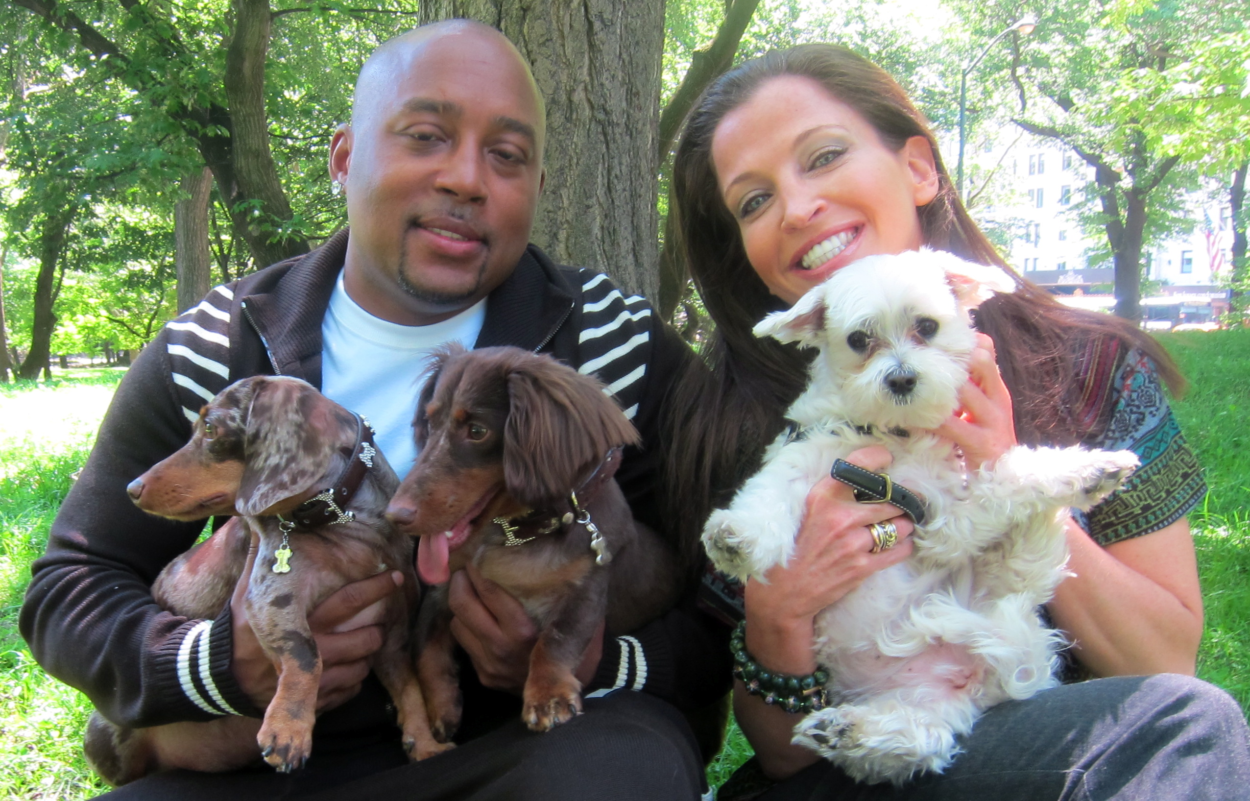 Daymond John carrying its two dachshund dogs