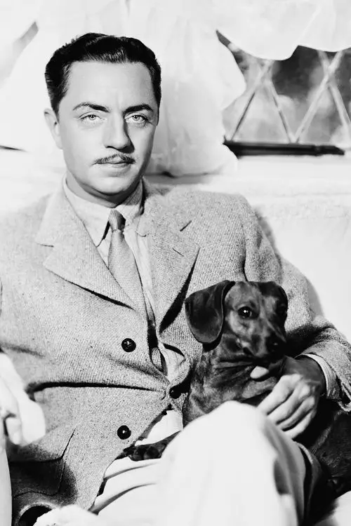 William Powell with his dachshund dog sitting on his lap