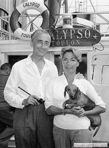 Jacques Cousteau with her wife carrying their Dachshund