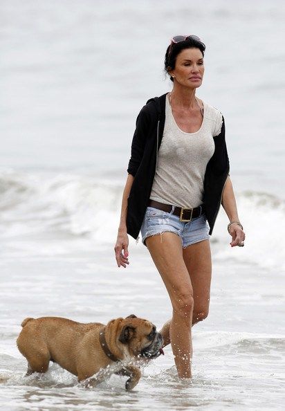 Janice Dickinson walking by the seashore with her English Bulldog