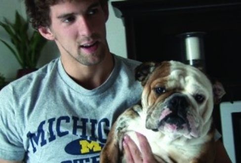 Michael Phelps carrying his English Bulldog