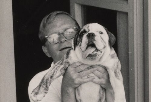 Truman Capote holding up her happy English Bulldog puppy
