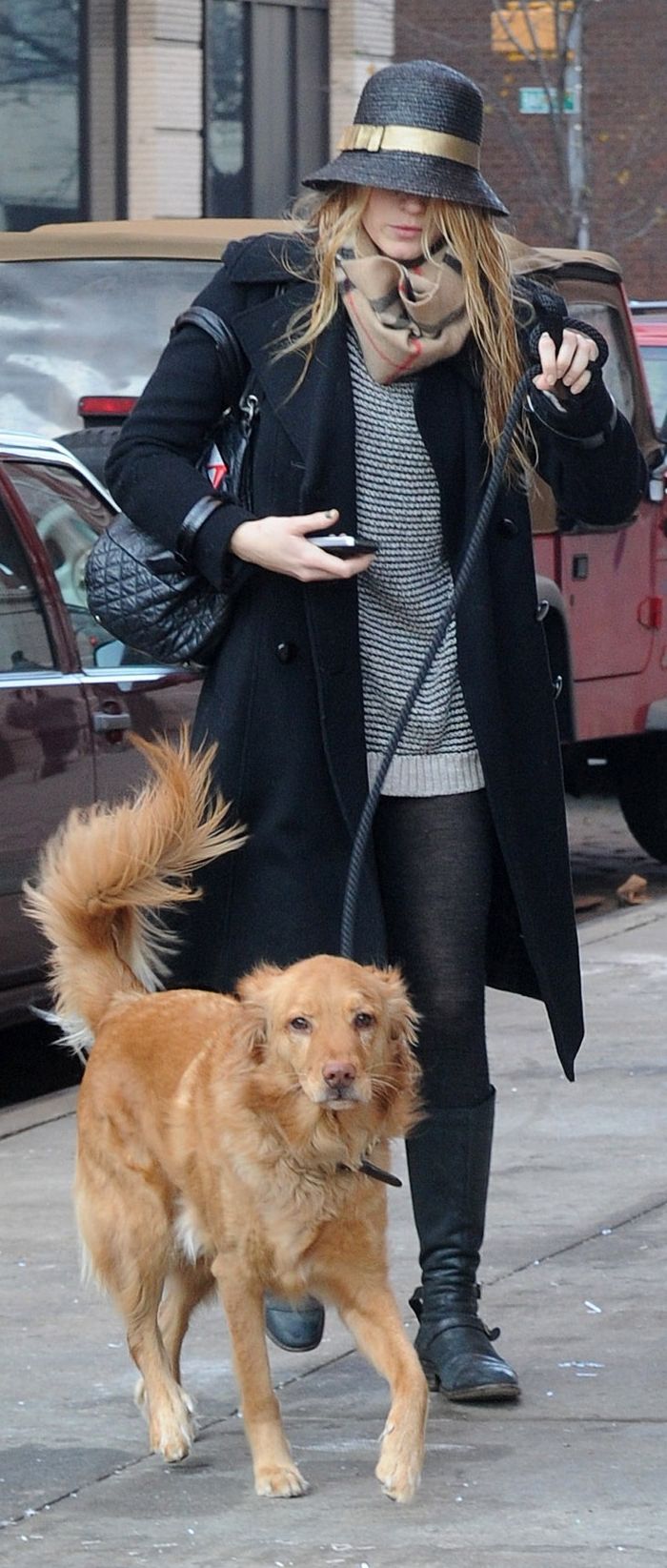 Blake Lively in the street with her Golden Retriever on a leash